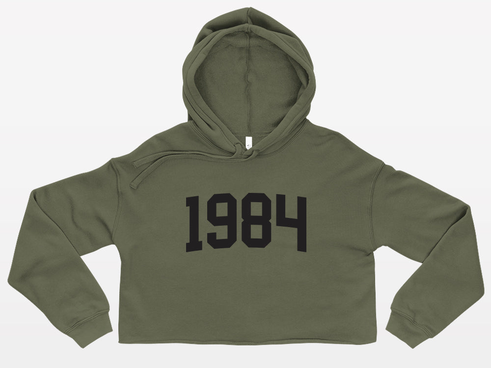 military green with black print birth year cropped hoodie 1984
