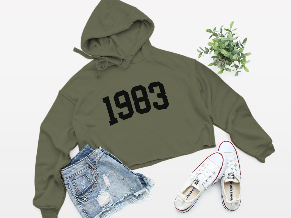 military green with black print birth year cropped hoodie 1983